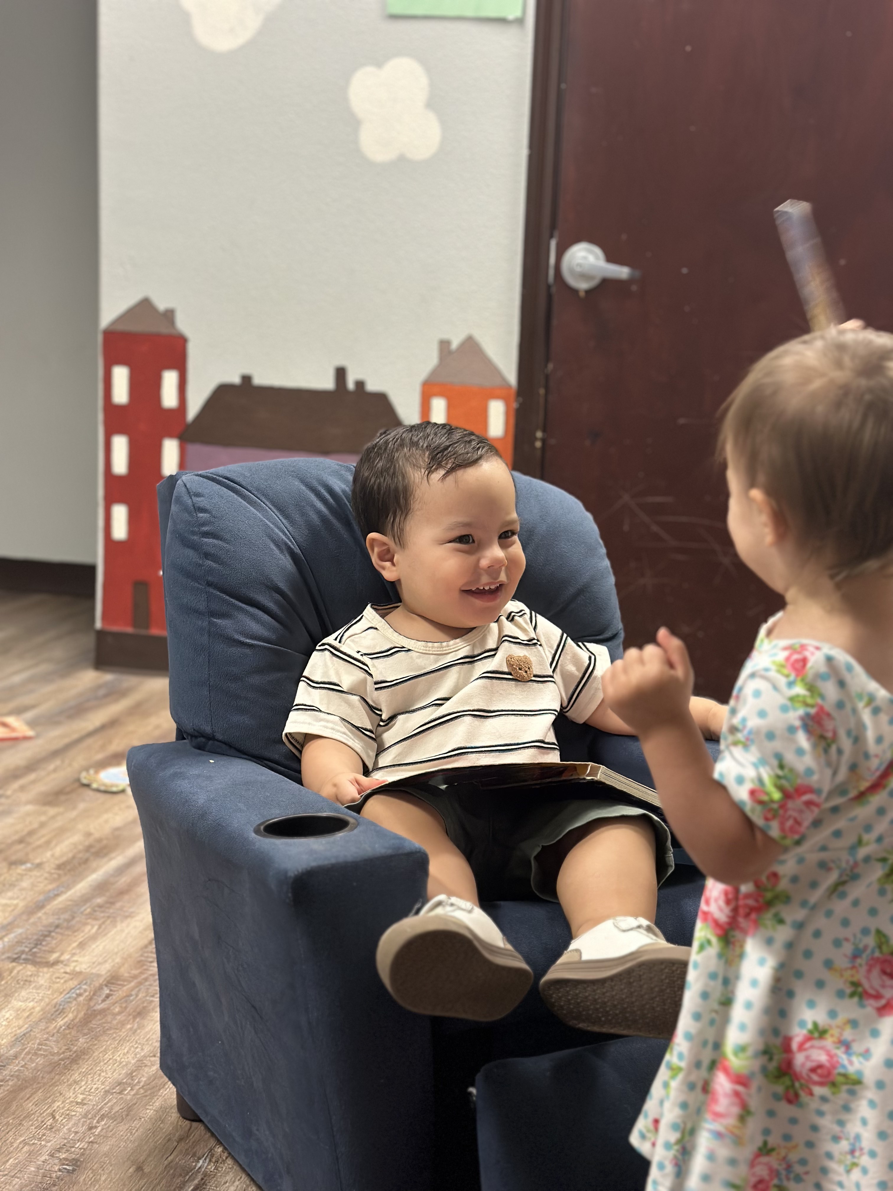 Children sharing a happy moment in the Gospel Light nursery